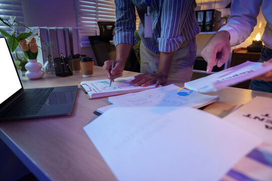 Business team analyzing financial charts in office meeting for strategic planning