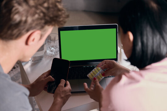 Green screen tablet supports family choosing medication through digital pharmacy. Concept of pharmacy applications, customizable advertising, shopping and technology.