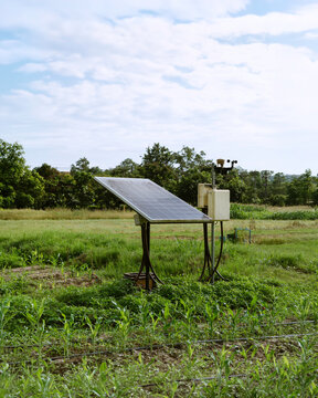 Off-grid solar-powered agricultural monitoring and smart irrigation station in a cultivated field, using photovoltaic energy for water management, precision farming, and sustainable agriculture.