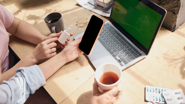 Overhead view shows phone laptop and medicine prepared for online order. Concept of ecommerce checkout, prescription planning, price comparison and home care.