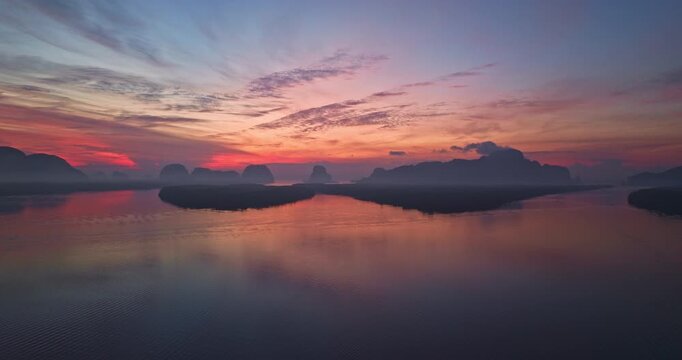 Aerial view of scenery sky reflection at Ban Sam Chong fishing village at twilight. Reflection of the dusk sky in a fishing village living, isolated island surrounded by mangrove forests.