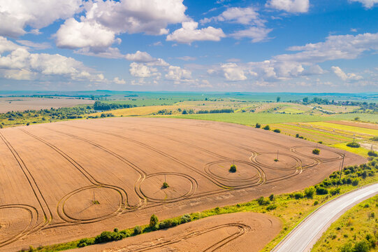 Top view of cultivated agricultural field and highway. Rural summer landscape