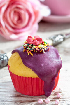 Decorated muffin in muffin paper on laid table