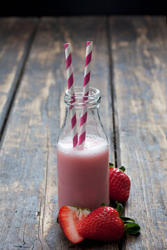 Glass bottle of strawberry smoothie