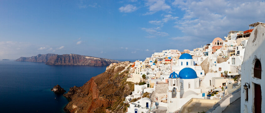 Greece, Cyclades, Thira, Santorini, Oia, View of blue dome and bell tower of a church with aegean sea