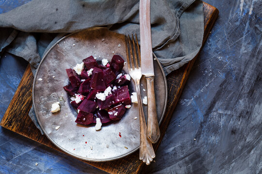 Metal plate of beetroot salad with feta and sea salt