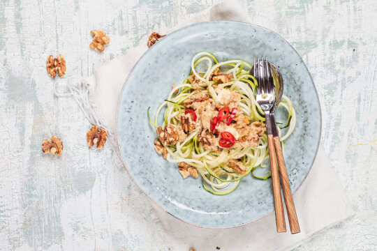 Spiralized zucchini and spicy walnut feta sauce on plate