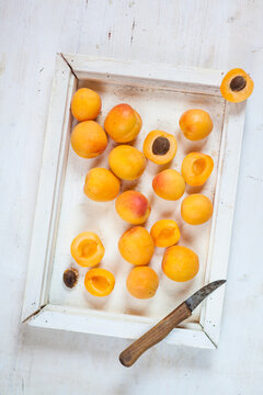 Wooden tray with apricots