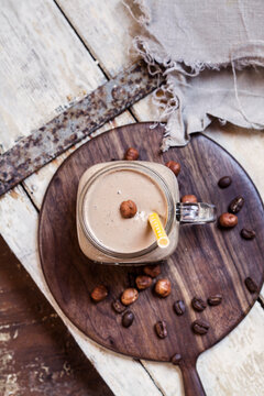Glass of smoothie with coffee, roasted hazelnuts and chia seeds