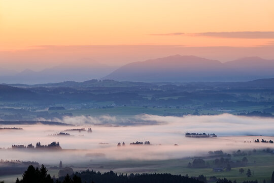Germany, Bavaria, Upper Bavaria, Allgaeu, Pfaffenwinkel, View from Auerberg near Bernbeuren, morning fog over Lech Valley during sunrise