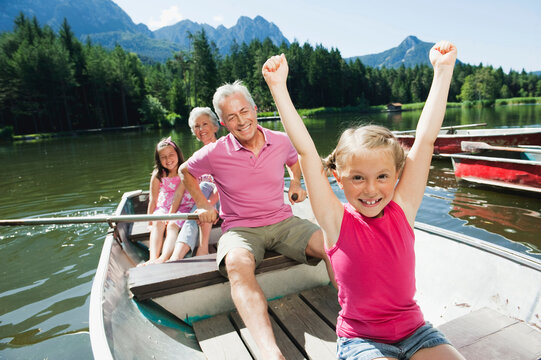 Italy, South Tyrol, Grandparents and children (6-7) (8-9) in rowing boat on lake, portrait