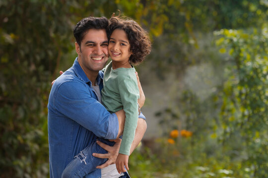 Happy man caressing her son in the park