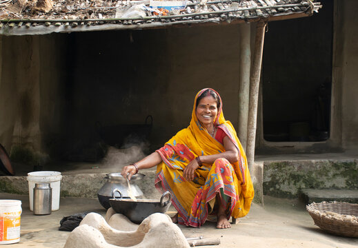 Rural Indian Woman cooking food in the Kitchen using firewood stove