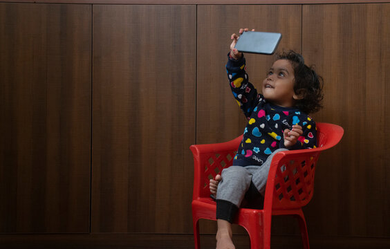 child looking in mobile screen