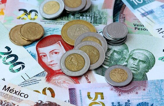 Mexican peso money banknotes and coins on table. Mexico cash bills of MXN currency