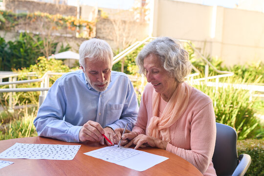 Senior Couple Doing Cognitive Rehabilitation Exercises Outdoors At Rehab Center For Brain Injury Recovery And Improved Mental Acuity And Focus