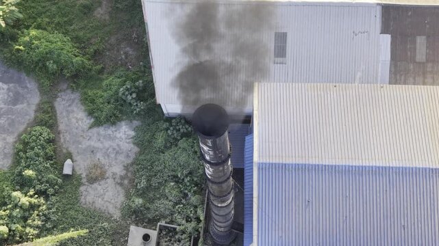 Dark Industrial Smoke Cloud Over Agricultural Fields and Rural Settlement in Bangladesh