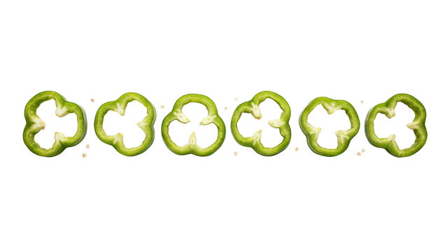 A horizontal row of six fresh green bell pepper slices arranged evenly on a black background, with small scattered, seeds between the rings