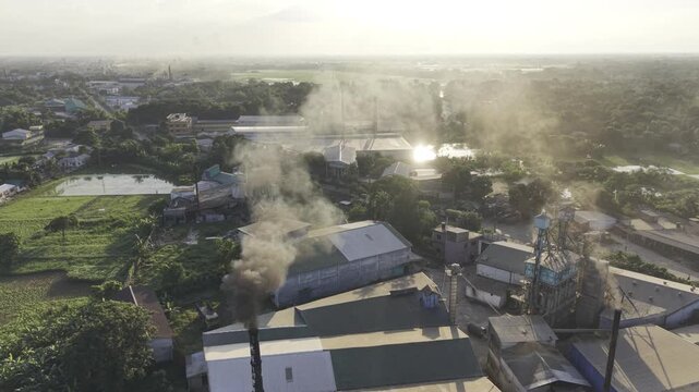 Aerial view of industrial smoke rising from a rice processing facility in Khajanagar, Bangladesh, highlighting air pollution, industrial emissions and environmental pressure within a rural agriculture