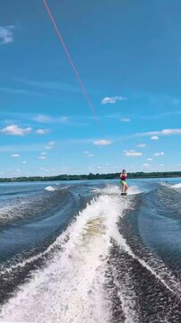 Athletic girl wakeboarding, healthy active lifestyle, water fitness and outdoor sports, young woman staying fit and active