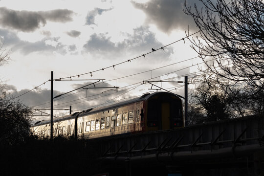 Silhouette of train under threatening sky