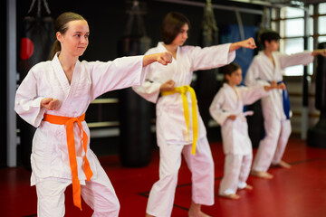 Group of children and teenagers practicing karate technique in gym © JackF