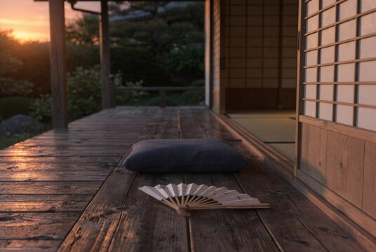 Tranquil Japanese Engawa Veranda with Fan and Cushion at Sunset