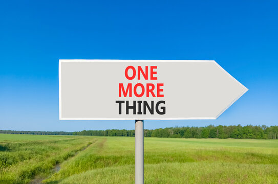 One more thing words symbol. Concept words One more thing on beautiful grey road sign. Beautiful blue sky green grass background. Business and one more thing concept. Copy space.