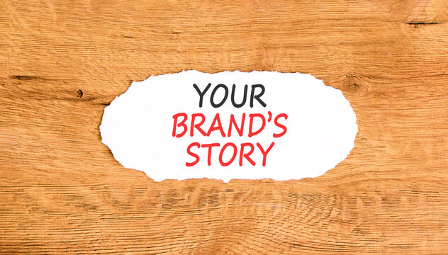 Branding and your brands story symbol. Concept words Your brands story on beautiful white paper. Beautiful wooden background. Business branding your brands story concept. Copy space.