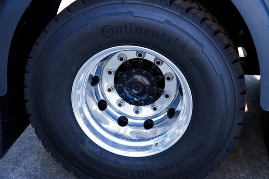 Gijon, Spain - August 11, 2026: Heavy-duty Continental Conti CrossTrac tire mounted on a polished Alcoa chrome alloy rim of mobile crane chassis 