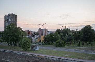 Cityscape view of featuring a brutalist apartment tower and construction cranes in Novi Sad, Serbia © Denis Renkas