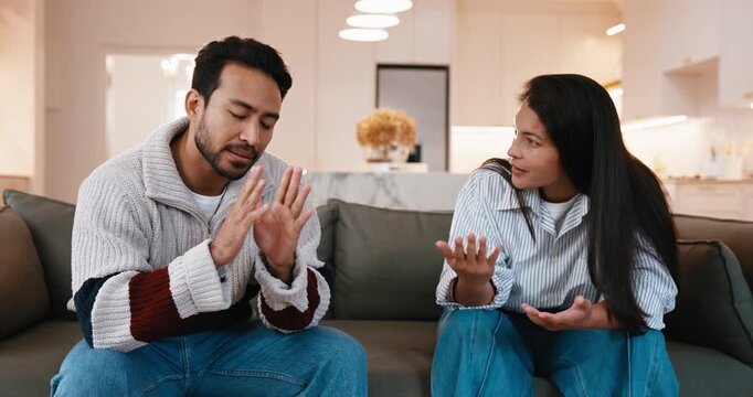 Couple, fight and disagreement with conflict on sofa for home argument, confrontation or break up. Frustrated, man and woman with issue for separation, toxic relationship or cheating affair in house