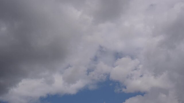 Overcast sky with layered stratocumulus and cumulus clouds revealing narrow blue gap, with cloud, overcast, sky, stratus detail, showing cumulus, stratocumulus, gray, blue context