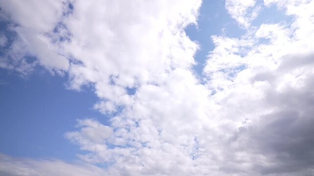 Expanding partly cloudy sky with bright central gap and advancing cumulus bank, with sky, cloud, cumulus, blue detail, showing white, gray, partly, overcast context