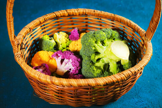 Multicolored cauliflower in a wicker basket. Green, yellow, and purple florets.