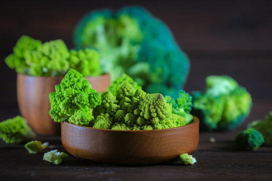 Romanesco cauliflower and broccoli on a wooden table.