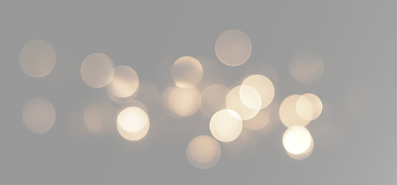 Abstract gold bokeh lights scattered in a wide line with warm glowing circles and festive sparkle overlay effect