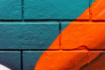 Art under ground. Beautiful street art graffiti background. The brick wall is decorated with abstract drawings house paint. Modern style urban culture of street youth. Abstract picture on wall © Yaroslav