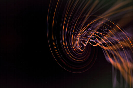 Abstract swirl of orange and purple light trails on dark background