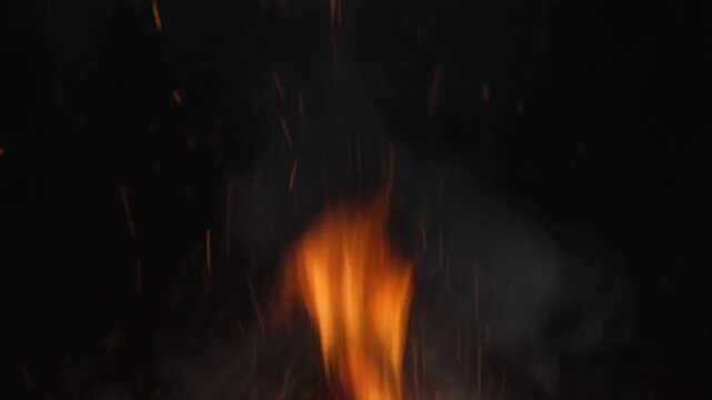 Seamless video loop of glowing fire embers and sparks flying slowly upwards against a dark black background, overlay asset, 4K