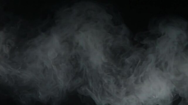 Seamless video loop of thick white atmospheric fog and smoke rolling slowly over a black background, overlay asset, 4K