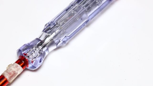 indicator screwdriver on a white background. Electricity test