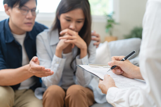 psychologist talking with a couple during mental therapy.