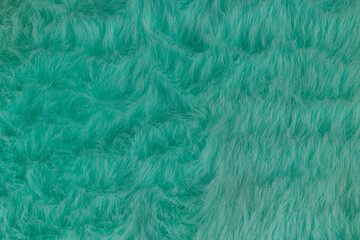Fototapeta premium Macro close up of turquoise green faux fur texture background