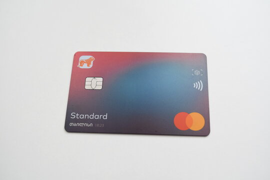Bank of Georgia Standard Mastercard debit card with a colorful gradient pattern, microchip, and Georgian script lettering, lying on a plain white background.