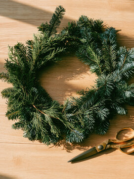 Dark evergreen wreath mockup detailed top down still life