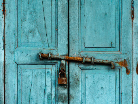 Old Turquoise Wooden Folding Doors with Rusty Latch and Padlock, Vintage Entrance