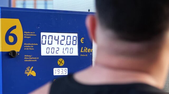 Close-up of a fuel pump display showing price and liters during refueling at a gas station