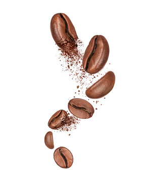 Crushed and whole coffee beans in the air on a white background