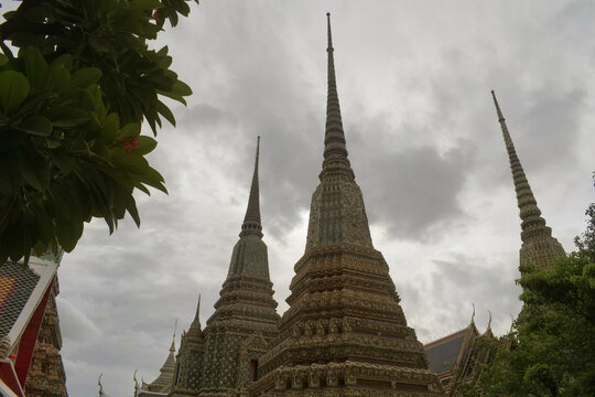 low angle view of towering ornate ceramic tiled chedis and stupas at wat pho the temple of the reclining buddha